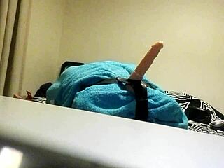 Gay guy uses dildo for solo anal play in homemade setting.