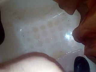 guy pees while jerking off and shoots jizz