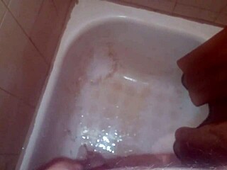 guy pees while jerking off and shoots jizz