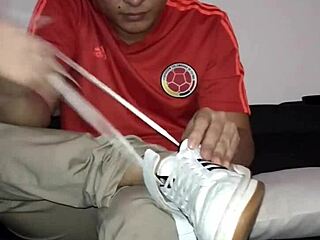 Master worships slave's feet in nylon socks during gay bdsm session.