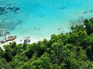 Sandy ass with red plug at beach