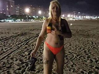 Blonde shows tits and pussy on the beach, voyeur style.