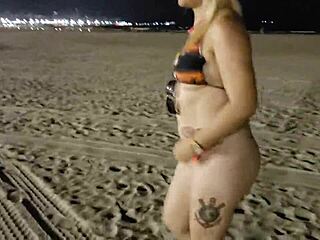 Blonde shows tits and pussy on the beach, voyeur style.