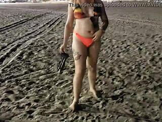 Blonde shows tits and pussy on the beach, voyeur style.