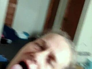 An old milf participates in a spitting ritual.