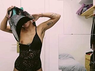 short tattooed girl with green hair does a hot striptease