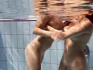 iva brizgina and paulinka dive into softcore lesbian fun in the pool with bikini-clad blonde and brunette.