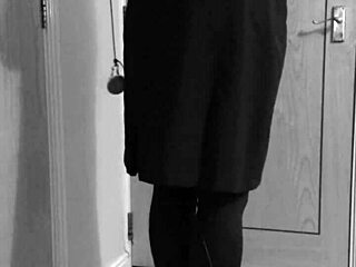 Crossdresser in uniform binds himself with handcuffs