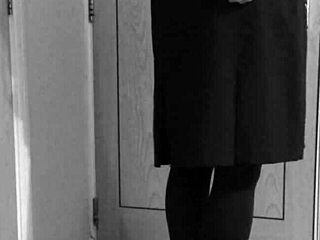 Crossdresser in uniform binds himself with handcuffs