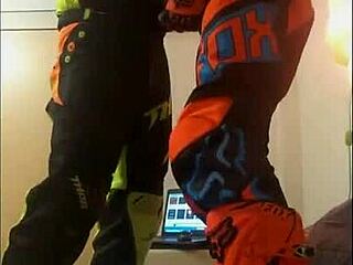 The guy in motocross gear gets a sloppy blowjob from his buddy in costumes