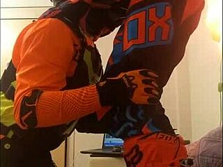 The guy in motocross gear gets a sloppy blowjob from his buddy in costumes