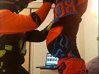 The guy in motocross gear gets a sloppy blowjob from his buddy in costumes