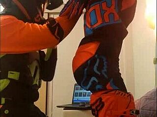 The guy in motocross gear gets a sloppy blowjob from his buddy in costumes
