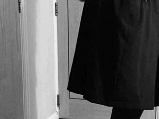 Crossdresser in uniform binds himself with handcuffs