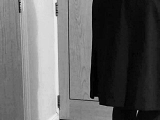 Crossdresser in uniform binds himself with handcuffs