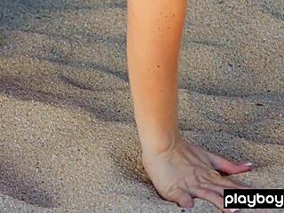 Behind the scenes, a nude surfer slut poses on the beach