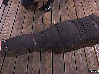 Is the mummified brunette enjoying the whipping or the pain?