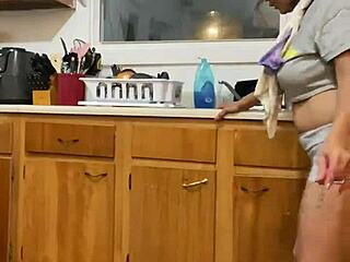 anna maria continues doing dishes while dancing in the kitchen