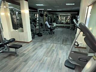 trainer offers new exercises to katty in the gym and they work out together