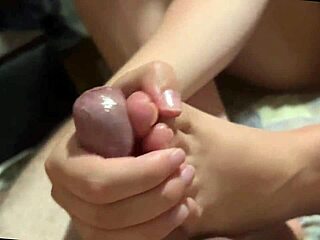 Young Babe Delivers Footjob Cock Closeup Leading to Cumshot. Amateur fetish scene captures first time homemade details.
