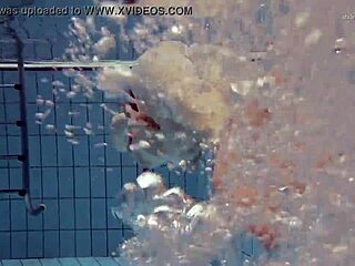 Tiny ass nastya in a dress splashes around the pool underwater with her natural tits exposed