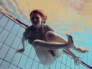 Tiny ass nastya in a dress splashes around the pool underwater with her natural tits exposed