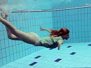 Tiny ass nastya in a dress splashes around the pool underwater with her natural tits exposed