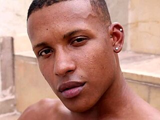 black stud stroking huge cock on home balcony