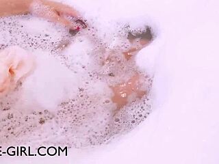 Stunning brunette model relaxes in a sensual bath during her photoshoot session.