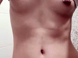 Novinha displays her pierced tits and shaved pussy