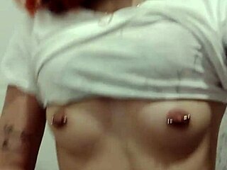 Novinha displays her pierced tits and shaved pussy