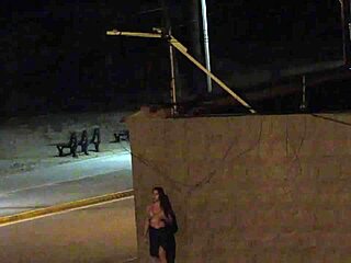 Beach security camera catches couple getting frisky in public spot.