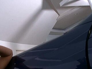 Brunette Romana Ryder bent over in public car