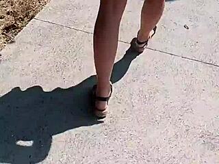 A woman walks naked on the street in public.