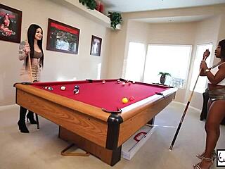 Lesbians Kris Riot and Harmonie Marquis enjoy a pool game.