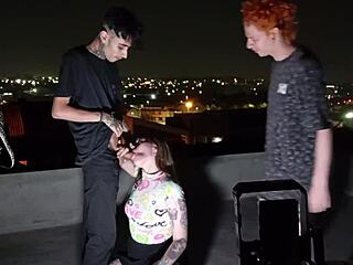 How does this young brunette handle two huge cocks on the roof?