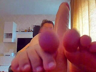 She sucks the big sex toy and gives a footjob