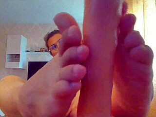 She sucks the big sex toy and gives a footjob