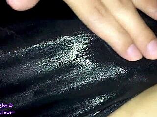 person in DARK BLUE SWIMSUIT gets LOTION applied for SLIPPERY effect