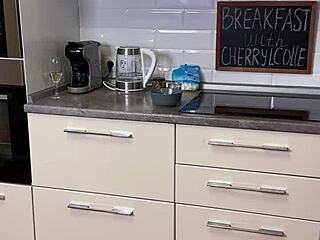 Beautiful mature Cherryl Colle enjoys breakfast in see-through leggings and glasses, teasing with her big tits.