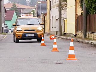 Blonde bombshell Barbie Sins takes a driving lesson in black lingerie