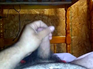 i'm jerking off on the bed, stroking my cock slowly.