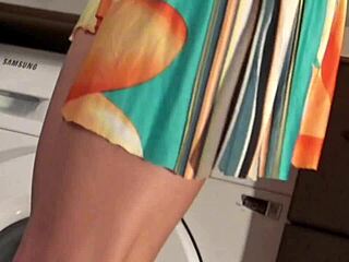 hot brunette babe removes panties under mini skirt in kitchen