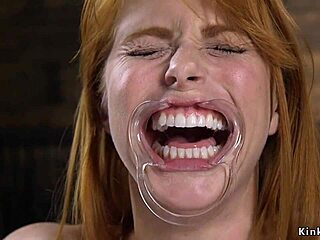 The natural busty redhead is bound in stock and whipped roughly