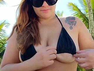 african woman wears short bikini and goes to beach seeking attention.