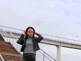 Hey, this brunette rocks tight leather leggings, high heels, and biker jacket outdoors! 🔥👢