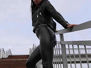 Hey, this brunette rocks tight leather leggings, high heels, and biker jacket outdoors! 🔥👢