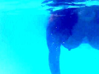 Melissa the Mermaid Swims Gracefully in the Pool with Tattoos and Brown Eyes