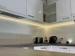 Hey, check out this hottest redhead tattooed cheerleader in over knee socks flashing see through panties in kitchen?