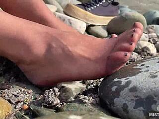 Goddess unveils messy nylon feet in torn pantyhose by river bank